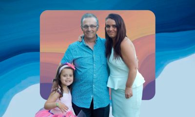 A family photo of Rachael with her daughter Brooke and father Kevin set against a blue, pink, purple backdrop