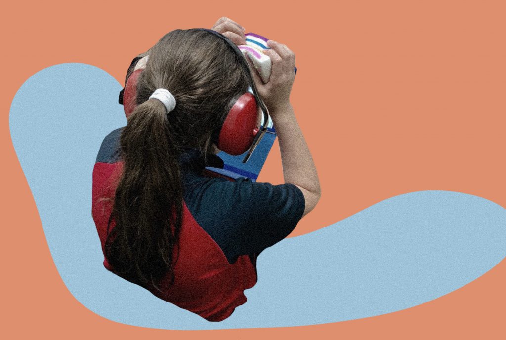 An image cutout of a student shows her wearing noise blocking headphones. The image is set against an orange and blue backdrop