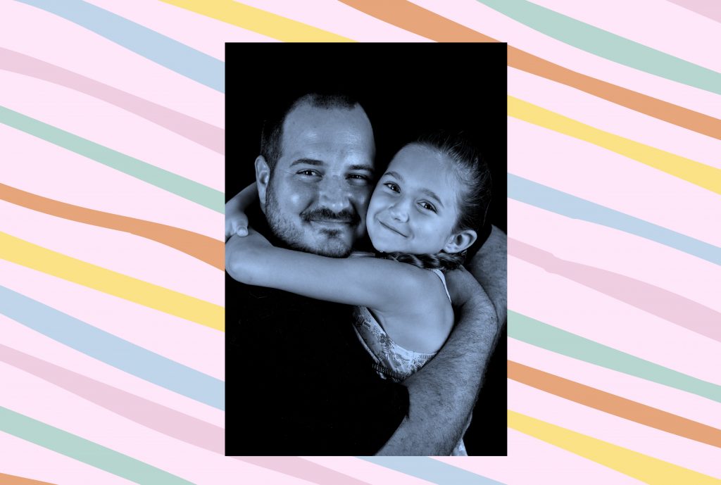 A photo of Philippe and Emma hugging, with a blue tint, is set against a light pink patterned background with loose, diagonal lines in orange, yellow, green and light blue.