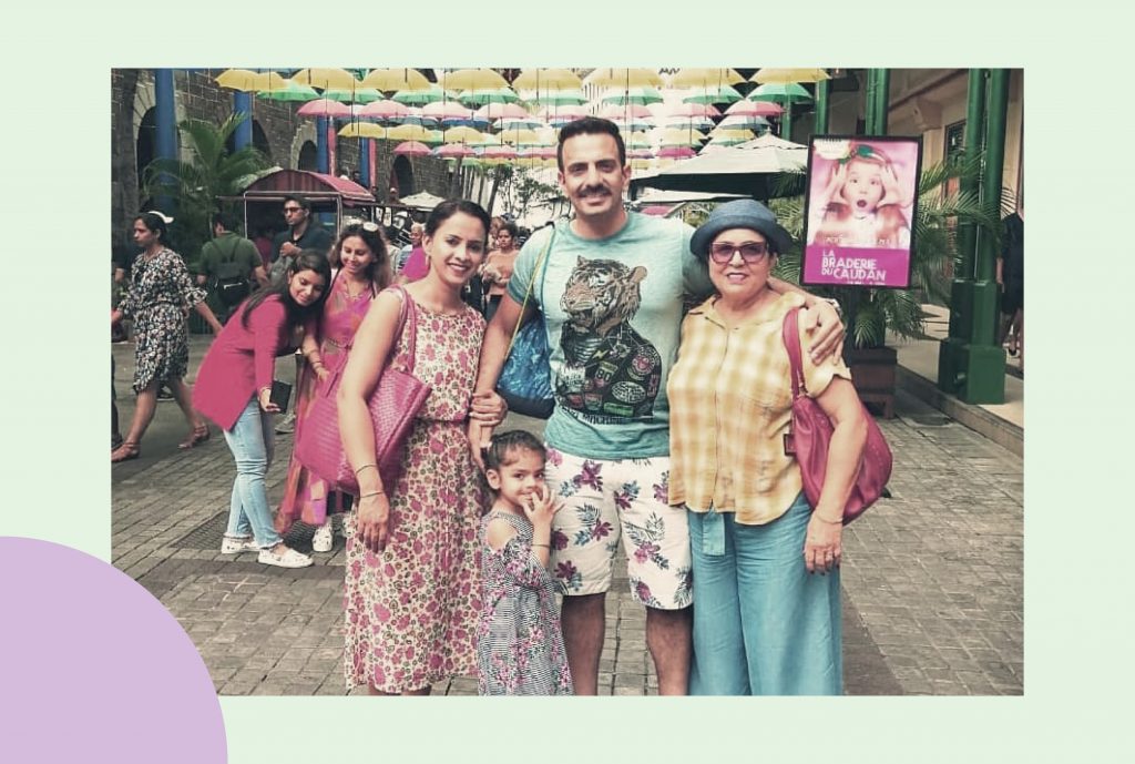 A group photo of a family of four — a man, two women and a child posing in front of a tourist spot at Maldives