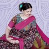 A photo of Vaishali Joshi in a printed black and pink spree set against a purple, patterned background