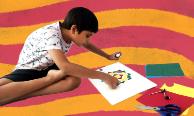 Madhav Kalra, a child on the autism spectrum is colouring on a paper. The background has an alternate curve pattern.