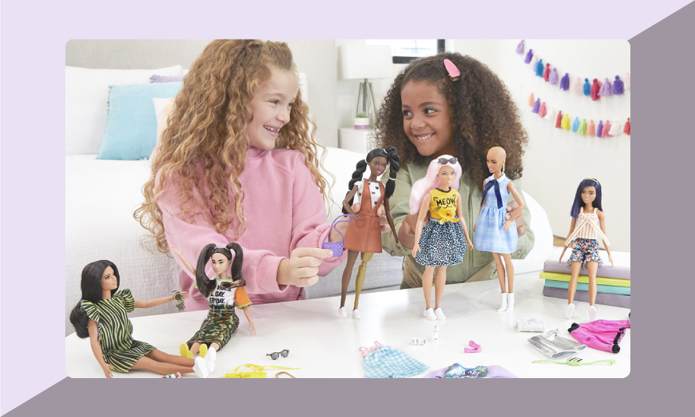 Image of two girls playing with Barbie dolls